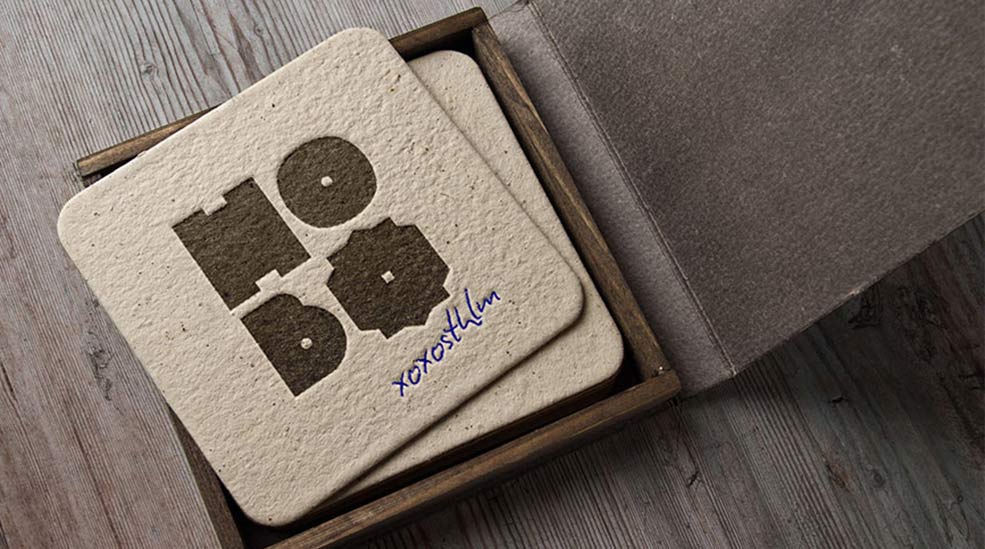 Brown cardboard coaster with logotype at hotel Hobo in Stockholm, Sweden