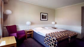 Spacious and trendy double room with a desk and a armchair at Tollboden Hotel in Drammen