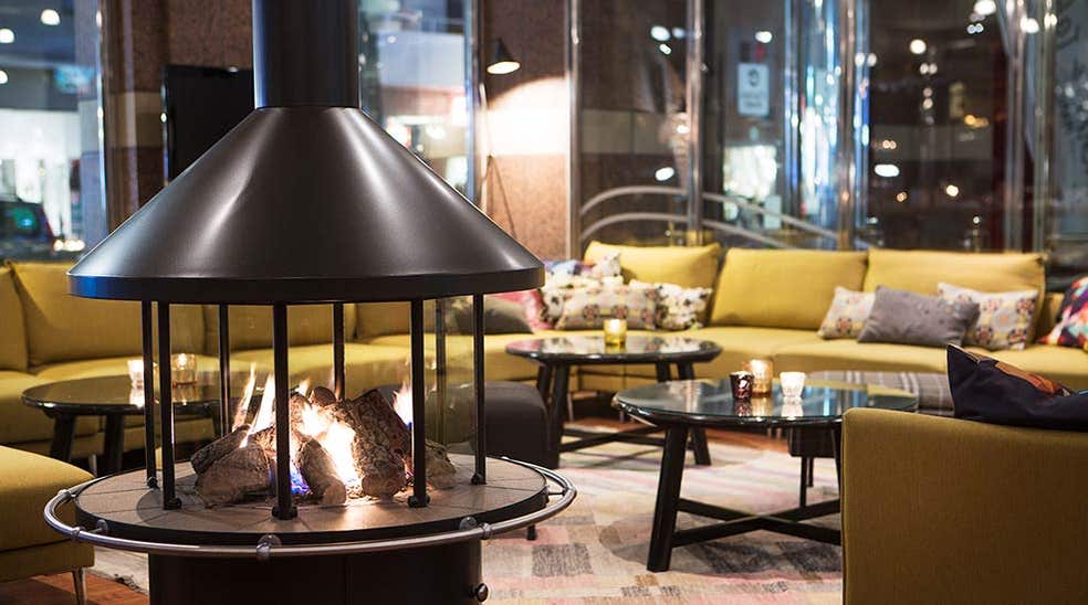 Lobby with comfortable seating and open fireplace at Hotel Orebro