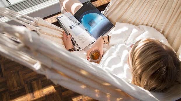Woman with book and tea in hammock at Elements Spa at Clarion Hotel Stockholm