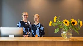 Two happy desk clerks at Hotel F6 in Helsinki, Finland