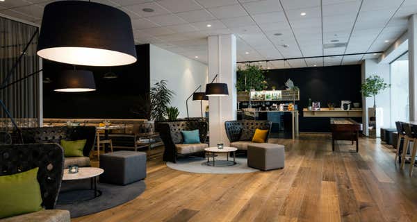 Lounge area with sofas, shuffelboard and bar at Quality Hotel Edvard Grieg Bergen